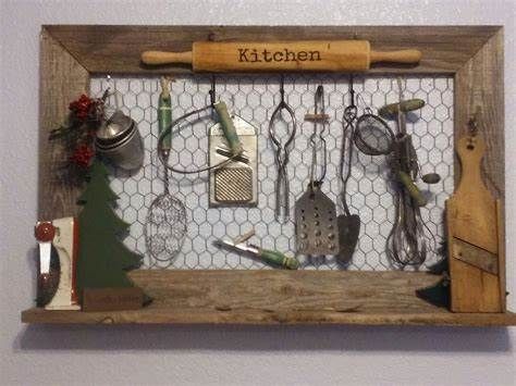 a wooden frame with various kitchen utensils on it and the words kitchen above them