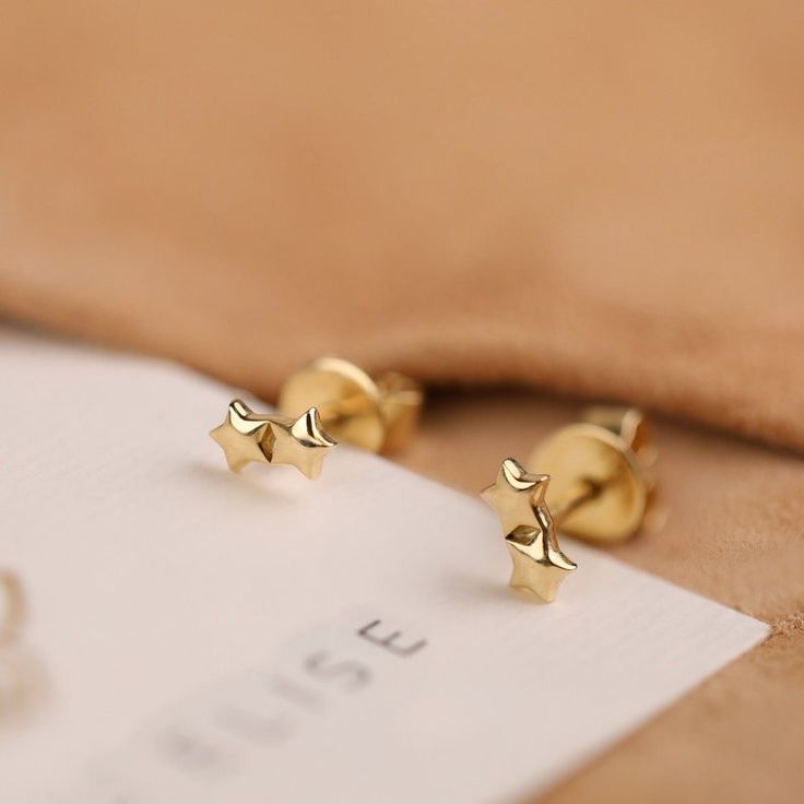 Stella Shine twice as bright with the Solid Gold Double Star Studs. Crafted from 14k gold (available in yellow, white, or rose gold), these earrings feature two delicate star silhouettes, each sparkling for a touch of celestial style. - Handmade- Solid gold- Dimensions: 6 x 3 mm All Sarah Elise stud earrings come beautifully boxed in suede pouches you can always use when traveling! Star Silhouette, Star Stud Earrings, Largest Butterfly, Ear Climbers, Star Earrings Stud, Jewelry Statement, Star Studs, White Gift Boxes, Shopping Websites