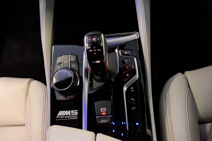 the interior of a car with an automatic gear stick and control knobs in it