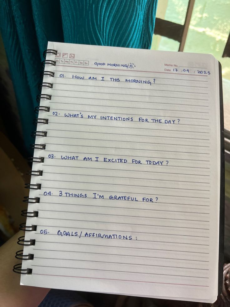 a notepad with writing on it in someone's hand