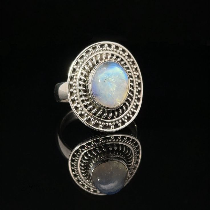 Beautiful oval moonstone ring with a sterling silver design. Materials: .925 Sterling Silver, Moonstone Dimensions: 4mm band, 19x22mm border, 9x11 stone Silver Sterling Silver Moon Shaped Opal Ring, Silver Sterling Silver Moon-shaped Opal Ring, Silver Moon-shaped Sterling Silver Opal Ring, Silver Oval Cabochon Moonstone Ring, Sterling Silver Oval Cabochon Moonstone Ring, Sterling Silver Moonstone Ring Oval Cabochon, Silver Moonstone Ring In Oval Cabochon Shape, Silver Moonstone Rings With Oval Cabochon, Oval Cabochon Moonstone Ring In Sterling Silver