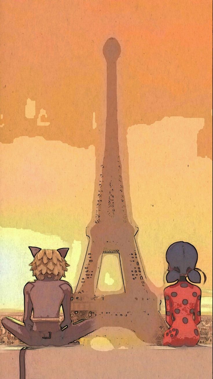 two people sitting in front of the eiffel tower