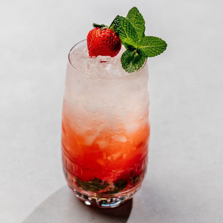 a strawberry and mint cocktail garnished with ice