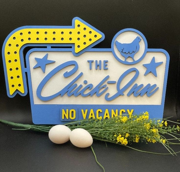 a sign that says the chick - up no vacany next to some eggs