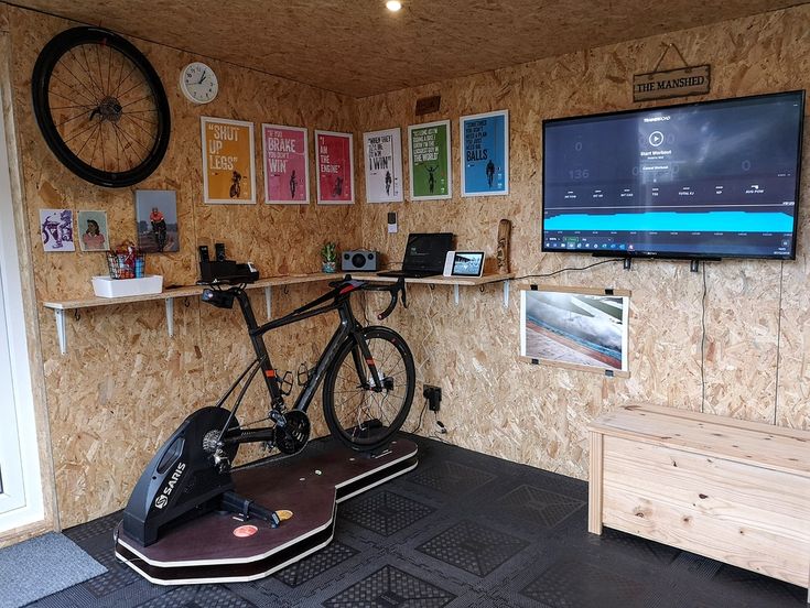 a bike parked in front of a wall mounted tv