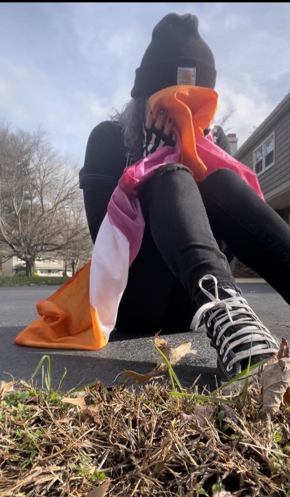 a woman sitting on the ground with her legs crossed