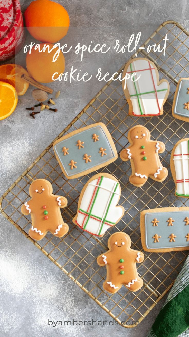 some cookies on a cooling rack with oranges and other food items in the background