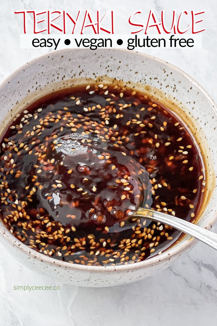 a bowl filled with sesame seeds and sauce