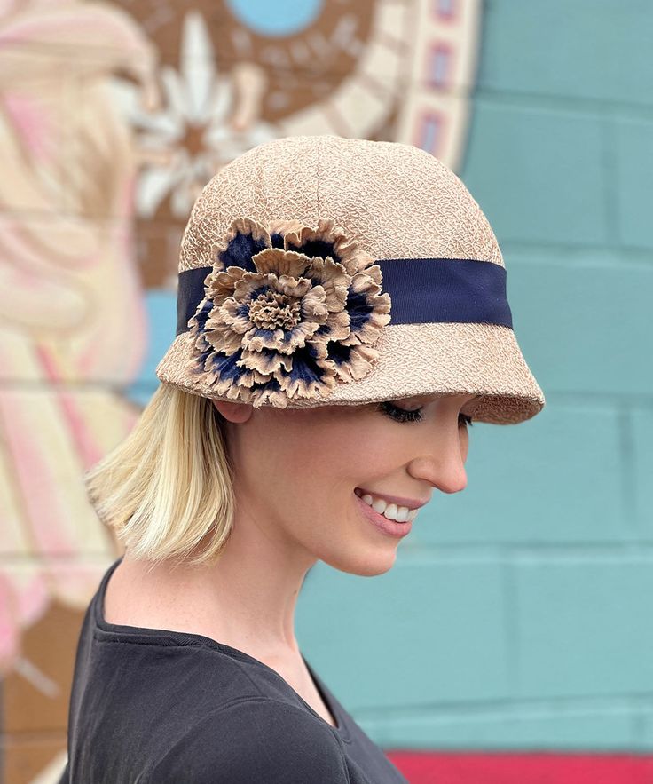 THE GRACE, handmade in Seattle, WA, USA, is a soft and flexible, 1920s style cloche hat. This hat is shown in Champagne Tumbleweed1 1/2" grosgrain band and assorted trims. The brim is 2" at center front, flaring out to 2 3/4" at side front, and curving back to 3/4" at center back of hat. The crown is made of six panels. Prices are as shown. These pieces are made-to-order and may be exchanged or returned for a store credit only. All sales of items with customizations or alterations are final. Ava Autumn Hat, Fancy Tea, Ruff Collar, Face Mask Men, Cloche Hats, 1920s Style, Cozy Coats, Fall Hats, Designer Hats