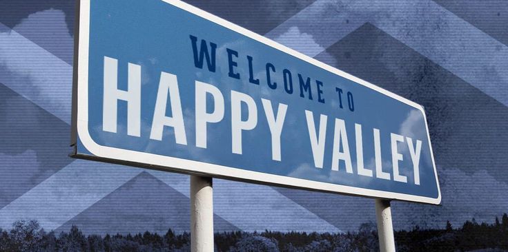 a welcome to happy valley sign in front of a blue and white background with mountains