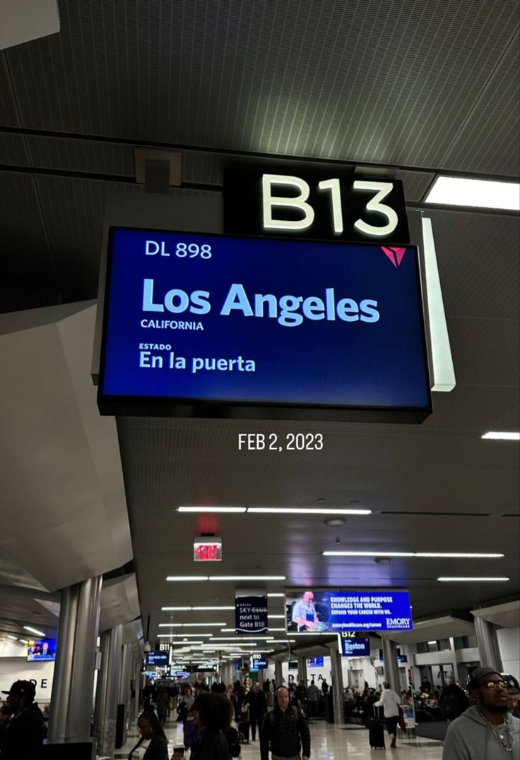 people are walking through an airport terminal