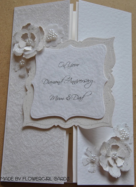 a white wedding card with flowers on it