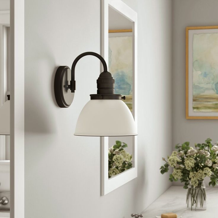 a bathroom with a sink, mirror and light fixture