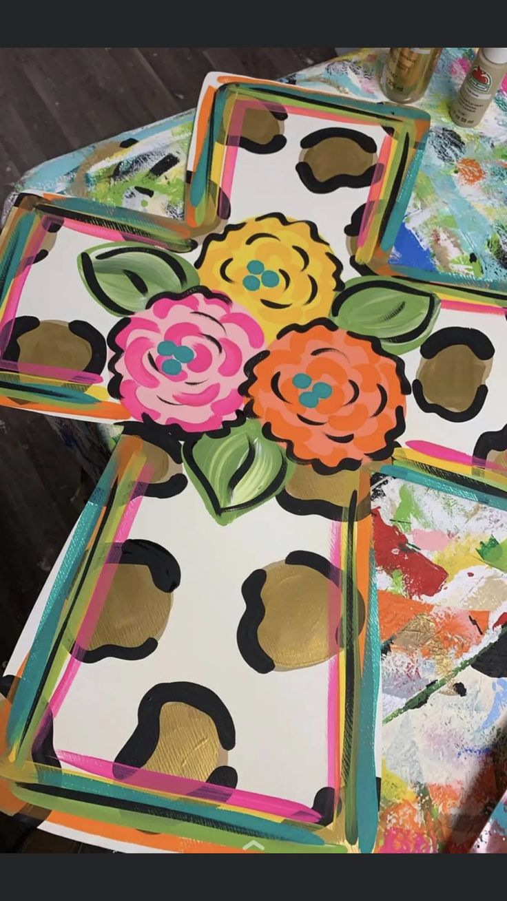 the table is covered in colorful paper and has flowers painted on it's sides