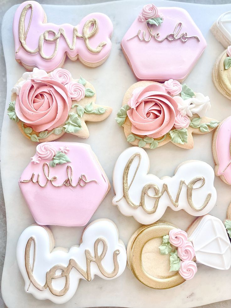 decorated cookies with the words love and roses on them are arranged in a rectangle