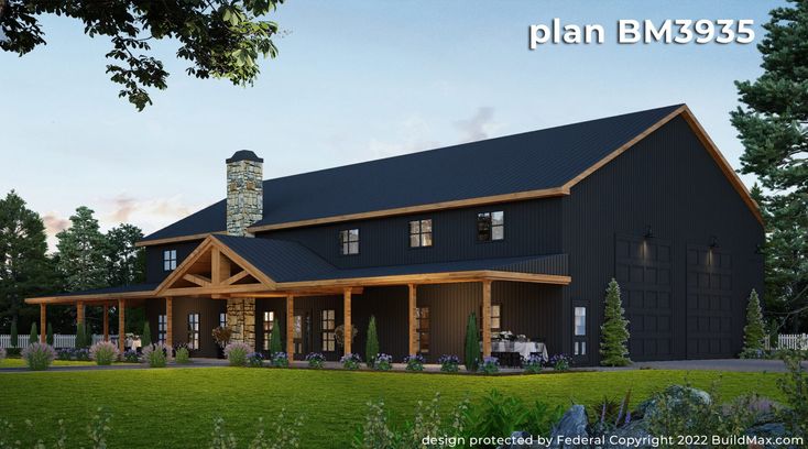 a large black house sitting on top of a lush green field