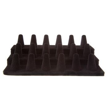 a black tray that has spikes on it and is sitting in front of a white background