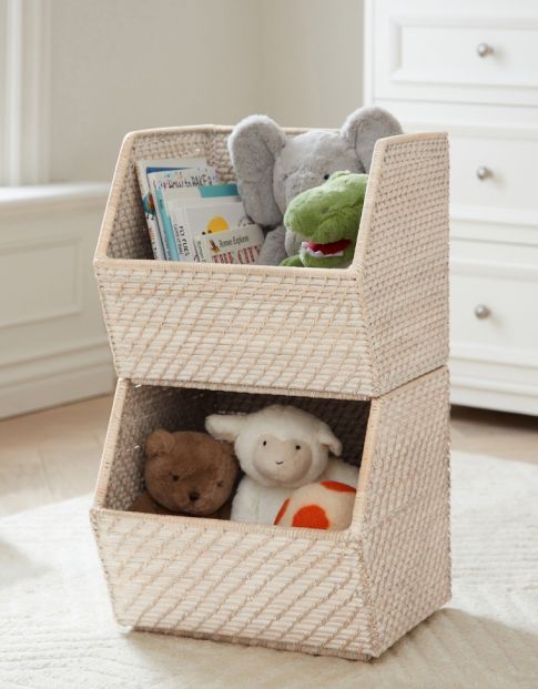 a basket with stuffed animals in it on the floor