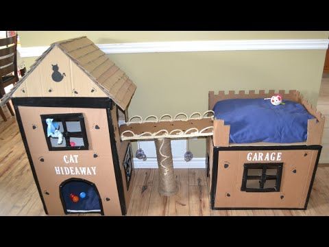 two cardboard houses made to look like cats