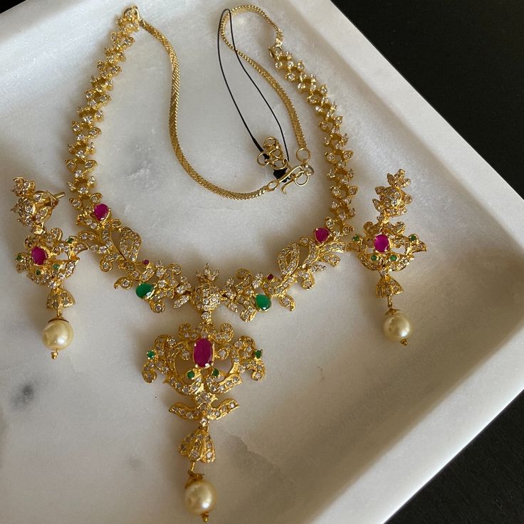 This Gold Plated Jewelry Set Is From Tessoro, Paired With Red & Green Zircon Stones. Great For Bridal Wear/Party Wear :) Comes With Tessoro Air Tight Pouch. Bridal Party Jewelry Sets, Bridal Party Jewelry, Ancient Jewelry, Party Jewelry, Plated Jewelry, Gold Plated Jewelry, Bridal Wear, Red Gold, Jewelry Set