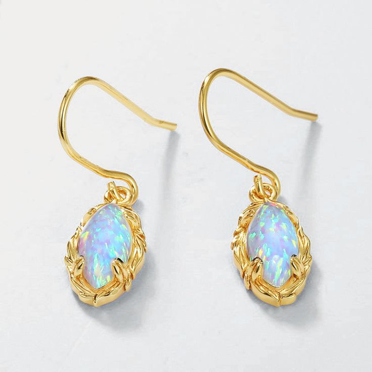 Sparkle and shine with the Opal Dangle Earrings. Their opalescent gems showcase a rainbow of hues, perfect for catching the light and radiating beauty. With a delicate dangle design, these earrings add a touch of elegance to any outfit. Elevate your style and turn heads with these stunning earrings! DETAILS Plating: 10K Gold Materials: 10K Gold on Silver, Simulated Opal, Zircon Size: 1.14 "*0.30"/29mm*7.5mm Weight: 1.57 g/pr Slight variations due to the individuality of each piece Blue Opal Gemstone Earrings, Elegant Iridescent Jewelry For Pierced Ears, Opal Drop Earrings With Gemstones, Opal Gemstone Drop Earrings, Elegant Opal Gemstone Drop Earrings, Elegant Iridescent Pierced Earrings, Opal Drop Earrings As A Gift, Opal Teardrop Earrings As Gift, Gold Opal Drop Earrings