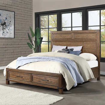 a bedroom scene with focus on the bed and storage drawers in front of the bed