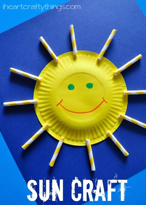 a paper plate sun craft with sticks sticking out of it