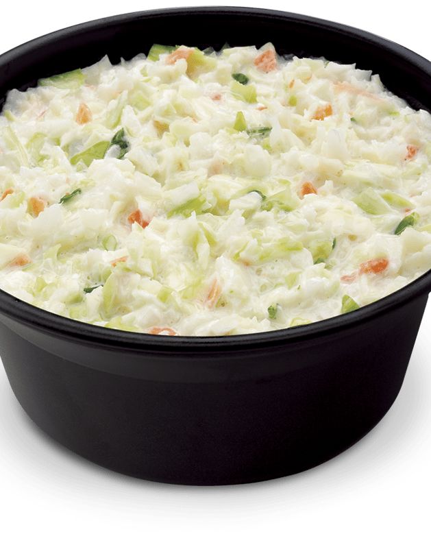 a casserole dish filled with coleslaw and carrots on a white background