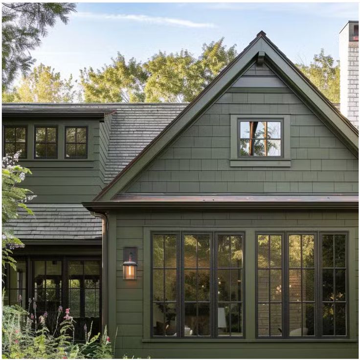 a green house with lots of windows in the front