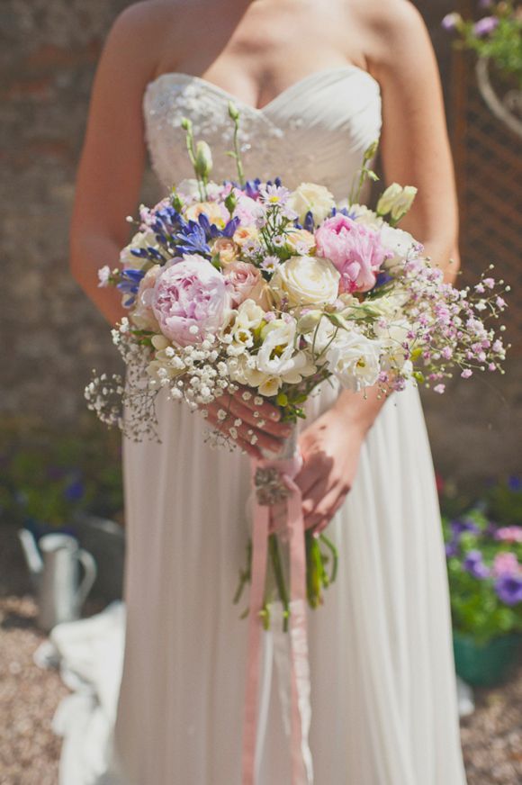 a woman in a white dress holding a bouquet of flowers on her wedding day with the caption wefollowpics com