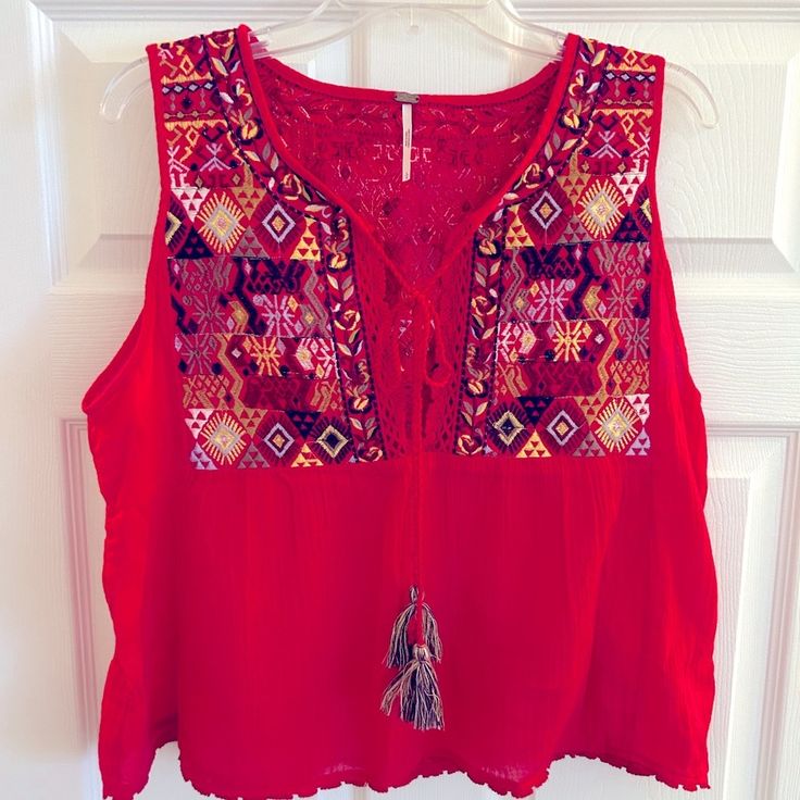 Beautiful Embroidered Front And Back Trapeze Style Tank Top. Tassle Tie In Front And Woven Details Top Front/Back And Stitched Hem. Size L Measurement From Shoulder To Hem 21 1/2” Like New (Never Worn) Embroidered Tank Top, Embroidered Tank, Style Tank Top, Free People Tops, Tank Top Fashion, Free People, Like New, Tank Top, Tank Tops