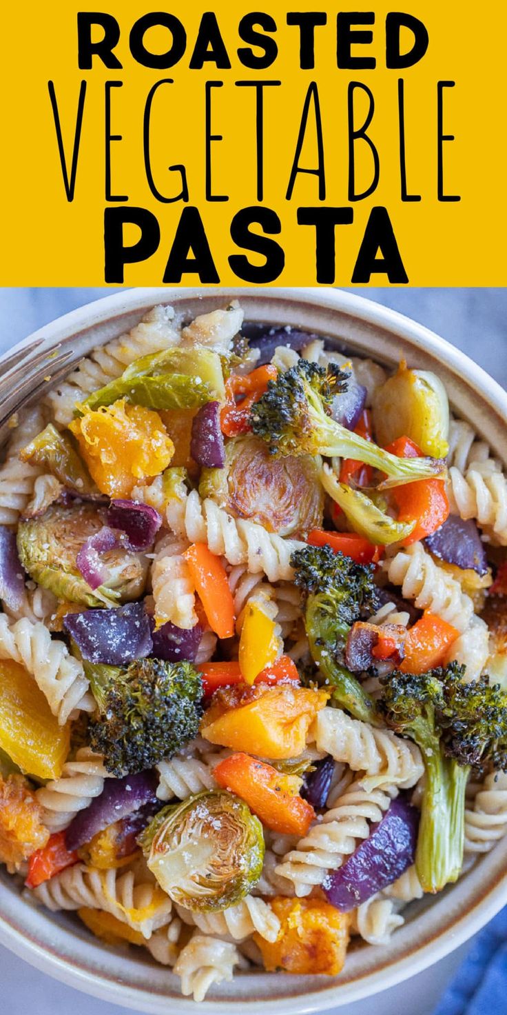 a bowl filled with pasta and vegetables on top of a blue cloth next to a yellow sign