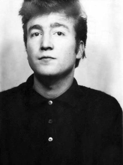 an old black and white photo of a young man with short hair wearing a collared shirt