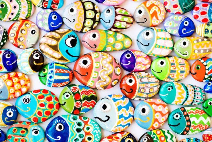 many different colored fish shaped rocks with eyes on each one and smiling faces on the other