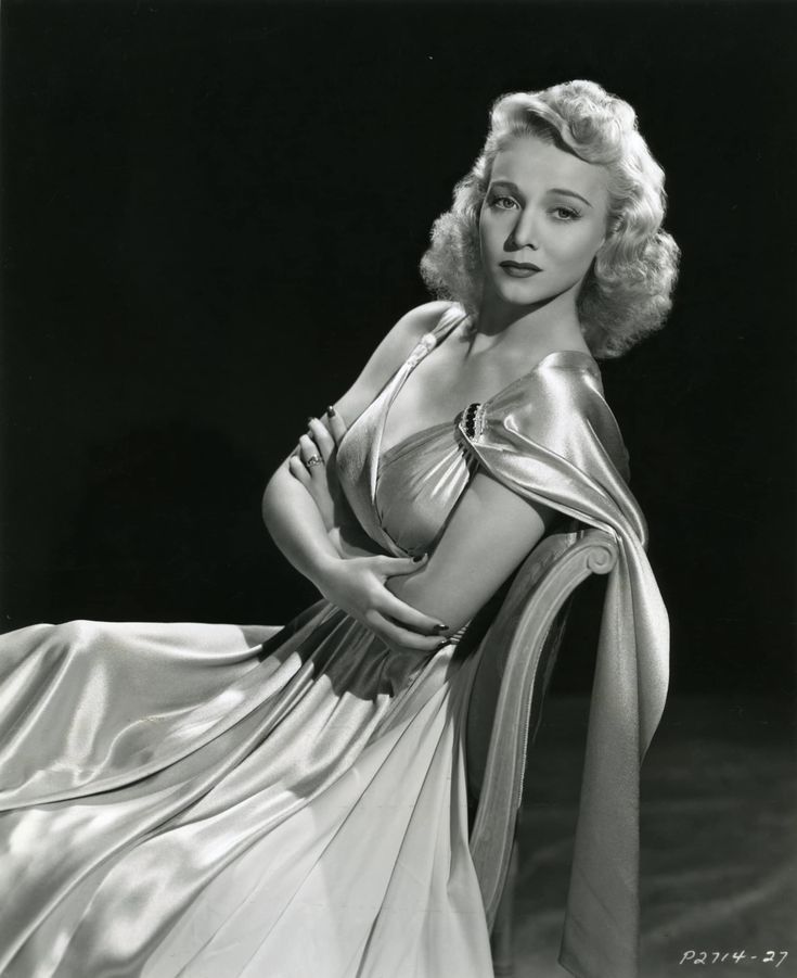 a black and white photo of a woman in a dress