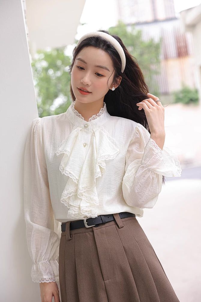 Chiffon blouse with a button down front lined with pearl buttons, ruffled Victorian front, frilly cuffs and lace trims all over. S: 14" across shoulders, 36" chest, 23" lengthM: 14.5" across shoulders, 37.5" chest, 23" lengthL: 15" across shoulders, 39" chest, 23" length Elegant Doll Collar Blouse For Spring, Chic Blouse With Lace Cuffs For Work, Lace Blouse With Lace Cuffs For Work, Long Sleeve Lace Trim Blouse For Work, Feminine Ruffled Blouse For Daywear, Classic Blouse With Lace Cuffs For Work, Spring Workwear Blouse With Lace Sleeves, Fall Workwear Blouse With Lace Trim, Formal Lace Blouse With Buttons