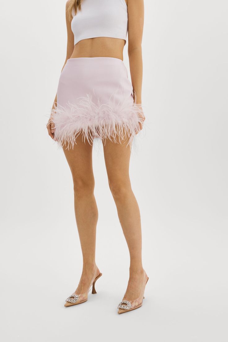 Indulge in luxury with the Magnolia feather trim mini skirt. This statement piece pairs beautifully with a blazer for a sophisticated look or a crop top for a more daring ensemble. Designed for the confident woman with a taste for opulence, the Magnolia skirt is a must-have addition to any fashion-forward wardrobe. Feminine Mini Skirt For Party, Feminine Mini-length Party Bottoms, Chic Skirt With Feather Trim, Feminine Mini Length Party Bottoms, Glamorous Skirt With Feather Trim For Night Out, Glamorous Fitted Mini Skirt For Spring, Chic Evening Mini Skirt For Summer, Feminine Mini Length Bottoms For Party, Chic Mini Skirt For Party Season