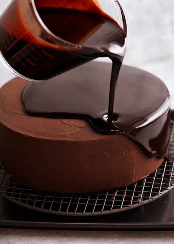 a chocolate cake is being drizzled with syrup