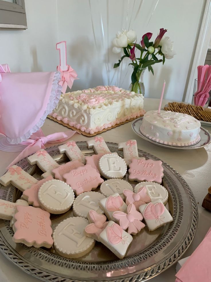 a table topped with lots of cakes and cookies