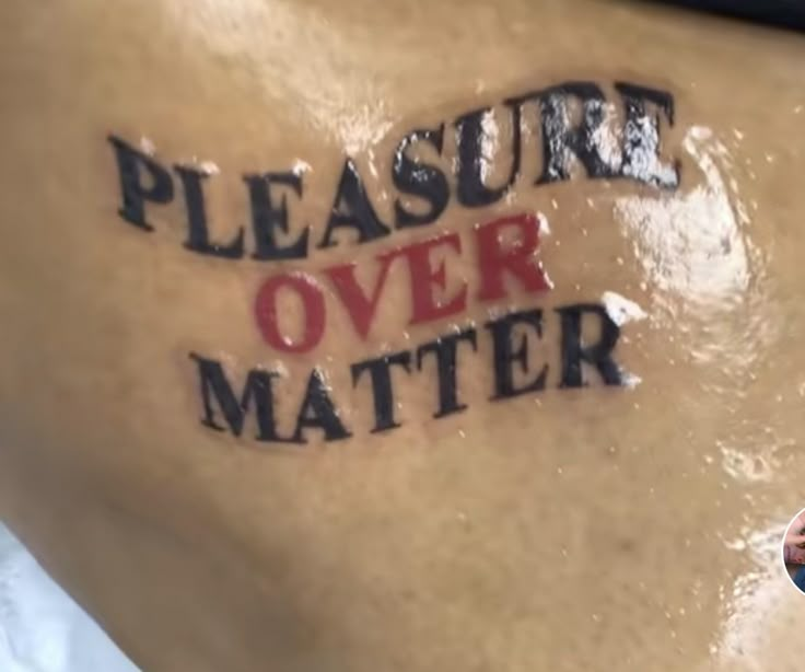 a woman with a message on her stomach that says pleasure over matter