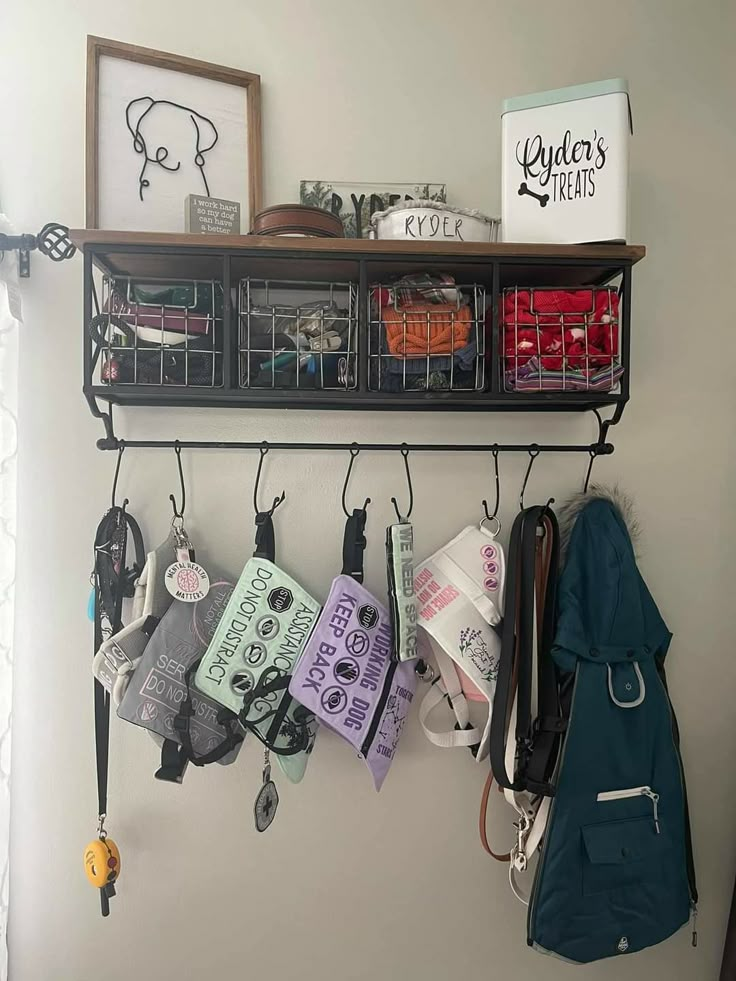 there are many items hanging on the wall in this room, including purses and other things