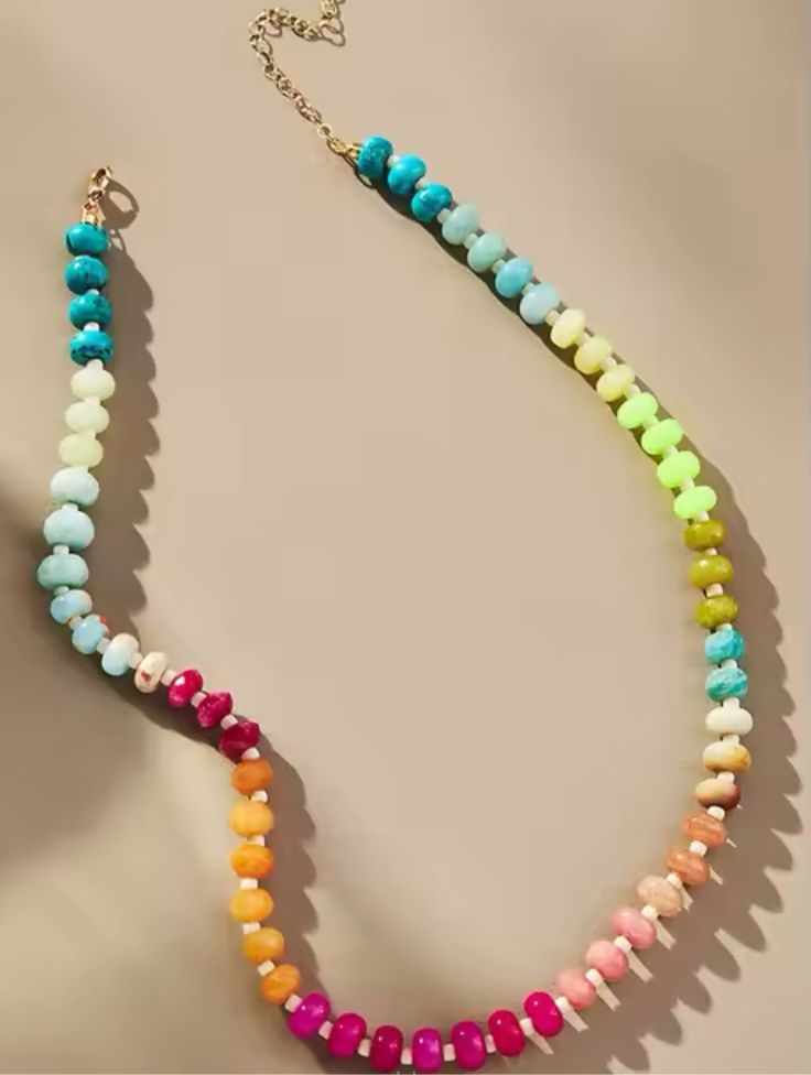 Indulge in luxury with our Rainbow Stone Necklace, featuring a stunning mix of beads in vibrant colors. Unleash your inner artist with our Rainbow Necklace. Length 16' with 1 1/2' gold extender and lobster claw clasp. This product was made by one of our partner companies. Fun Rainbow Necklaces With Colorful Beads, Playful Rainbow Necklaces With Round Beads, Playful Rainbow Beaded Necklaces, Playful Rainbow Necklace With Colorful Beads, Rainbow Multi-strand Beaded Necklaces, Stacked Earrings, Rainbow Necklace, Rose Earrings, Rose Gold Necklace