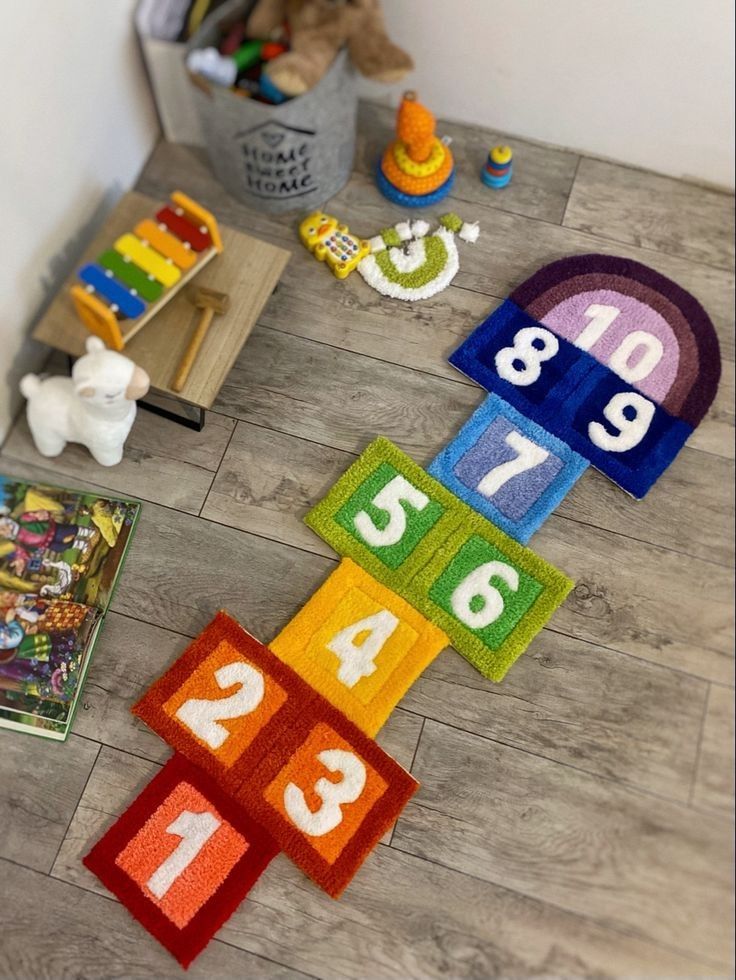 colorful rugs and toys on the floor in a child's playroom area