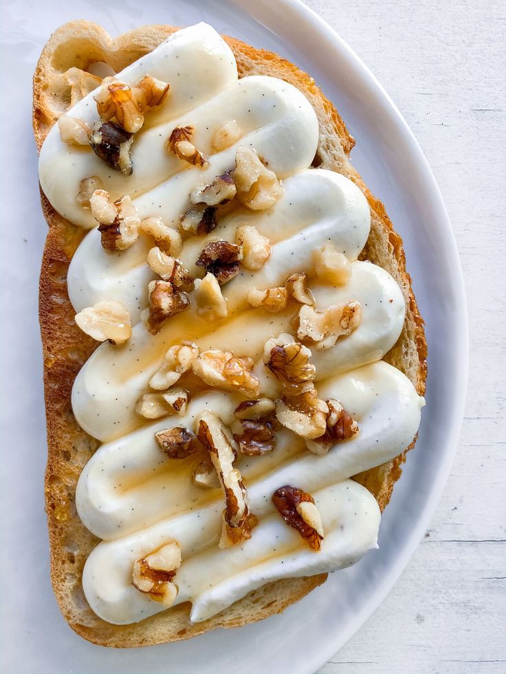 a piece of bread topped with bananas and nuts