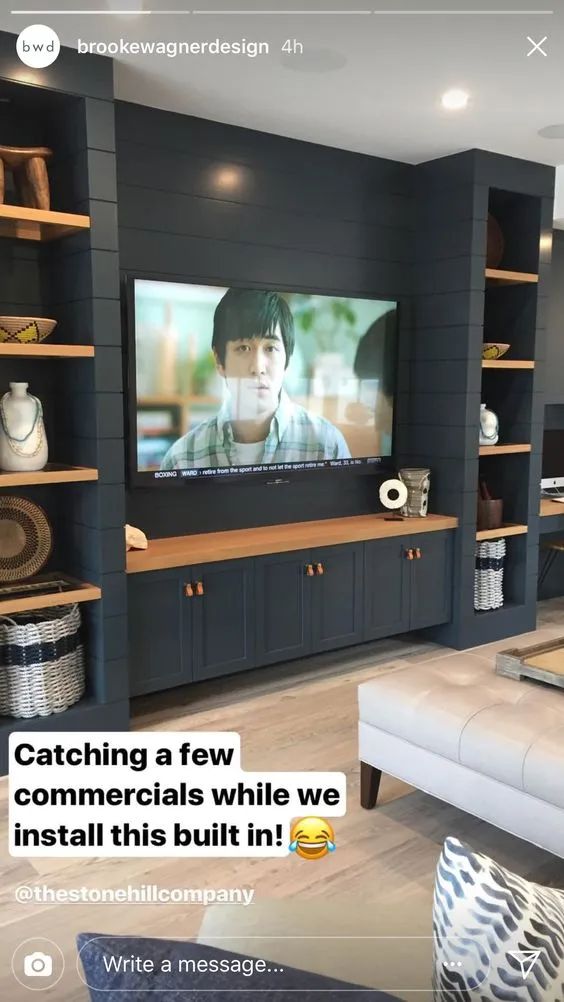 there is a television in the living room with shelves on it and a couch next to it