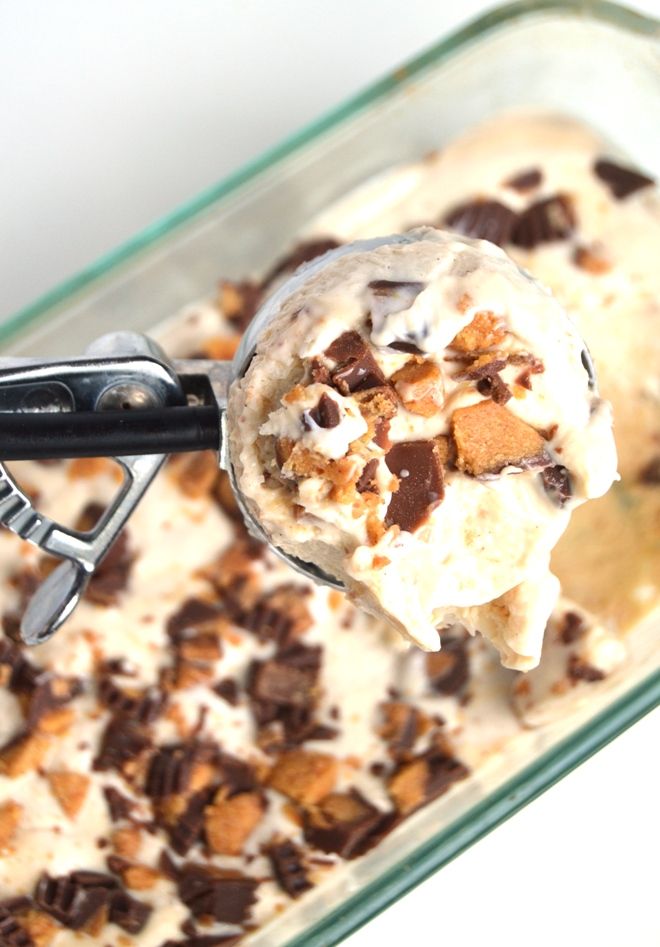 an ice cream sundae with chocolate chips and nuts on top in a glass dish