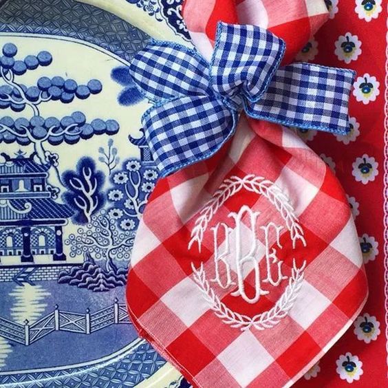 red, white and blue plates with monogrammed napkins