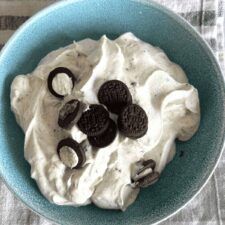 a bowl filled with whipped cream and oreo cookies