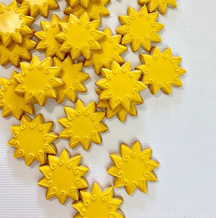 many yellow stars are arranged on a white surface