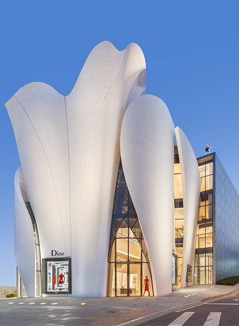 a large white building sitting on the side of a road